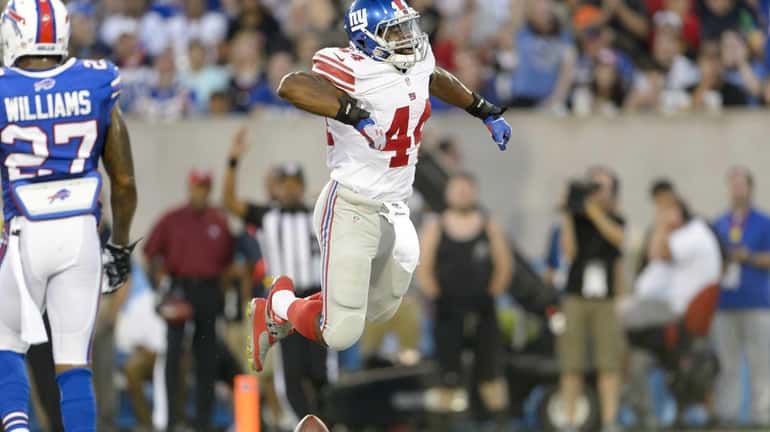 Giants running back Andre Williams celebrates after running in a...