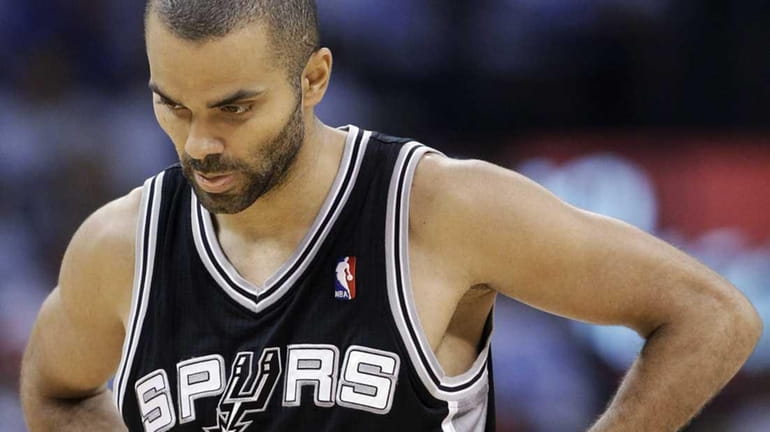 San Antonio Spurs guard Tony Parker, of France, heads to...