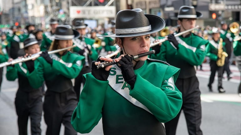 The Seaford High School Marching Band takes part in the...