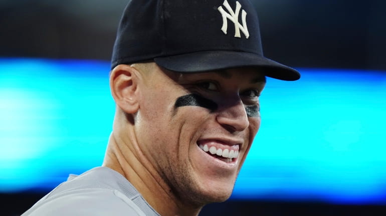 The Yankees' Aaron Judge smiles to the crowd during ninth inning...