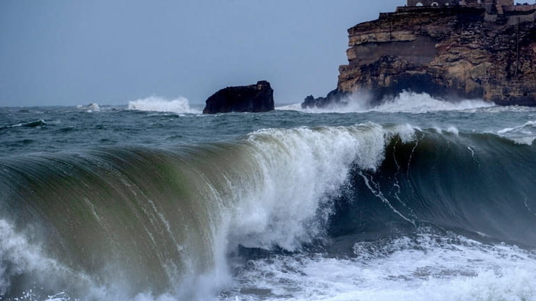 Big waves roll towards the beach of Nazare, Portugal, Wednesday,...