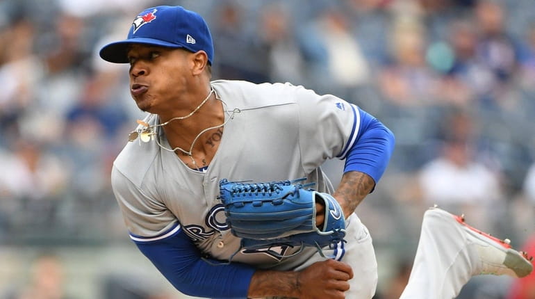 Toronto Blue Jays starting pitcher Marcus Stroman delivers a pitch...