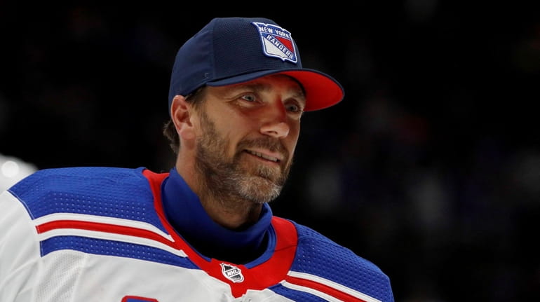 Henrik Lundqvist of the New York Rangers skates off the...