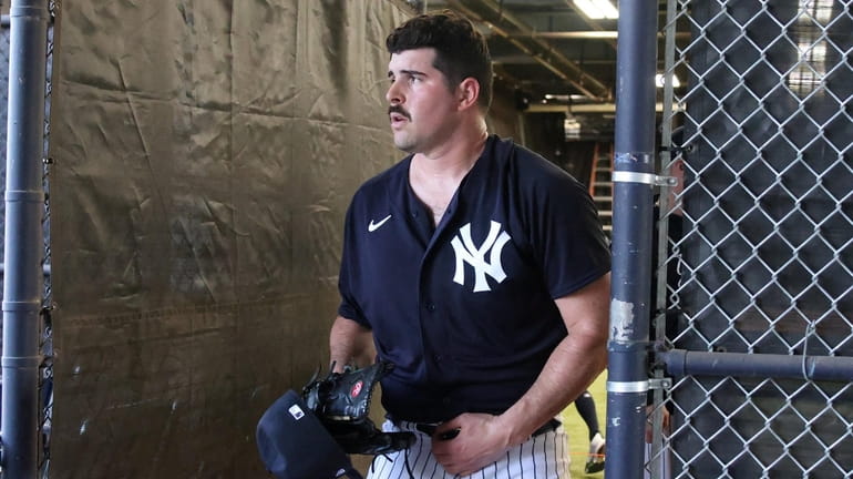Yankees pitcher Carlos Rodon throws a bullpen session during spring...