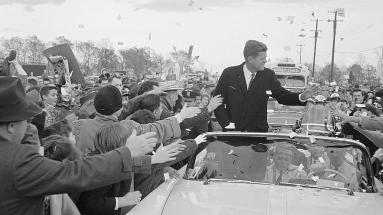Then-Sen. John F. Kennedy campaigns from his motorcade in Commack...
