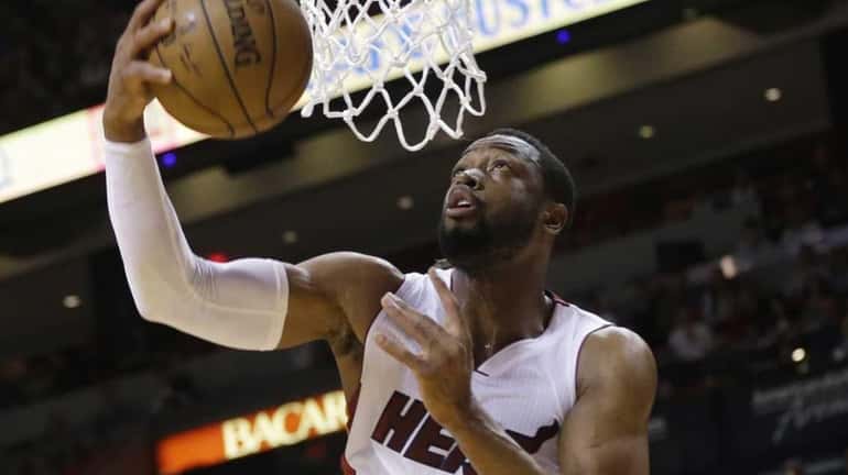 Miami Heat guard Dwyane Wade (3) shoots in front of...