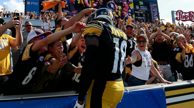 Diontae Johnson of the Steelers celebrates with fans after a...