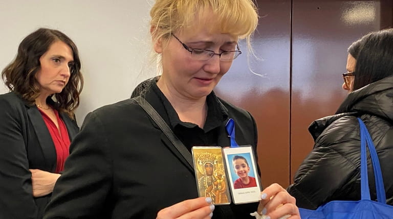 Justyna Zubko-Valva holds a photo of her son Thomas, the 8-year-old...