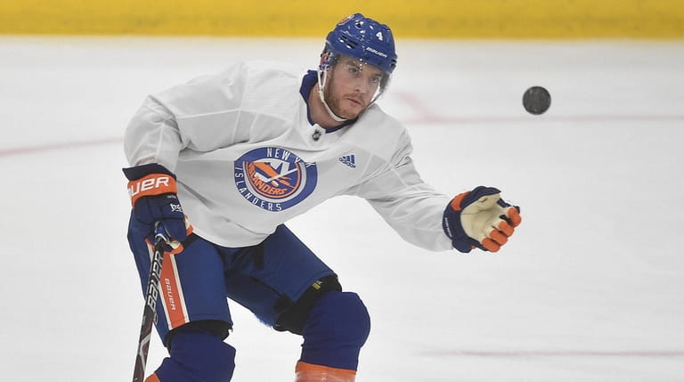 Thomas Hickey of the Islanders settles a bouncing puck during practice at...