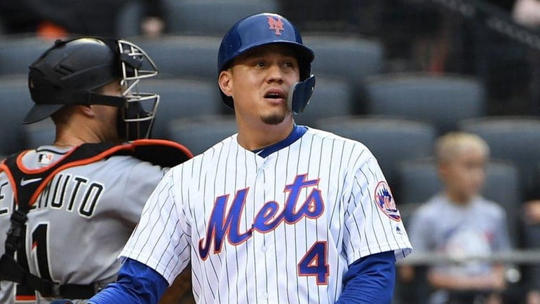 The Mets' Wilmer Flores reacts after striking out looking to...