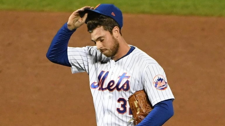 Mets pitcher Steven Matz reacts after giving up a solo...