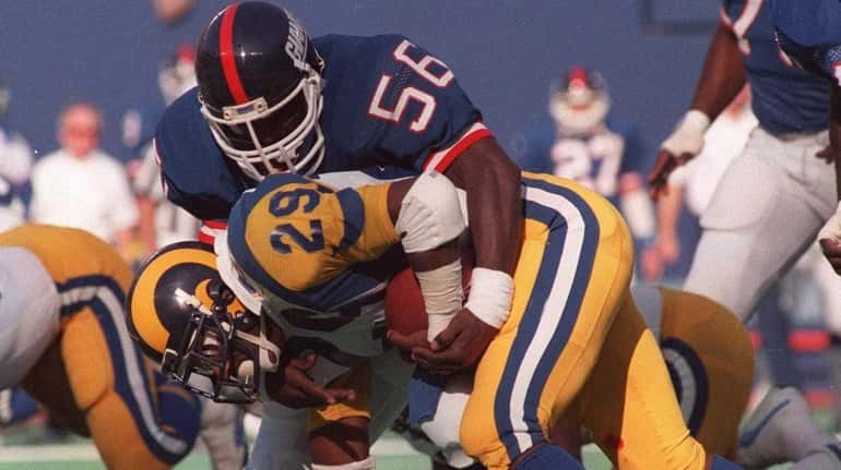 FILE--New York Giants linebacker Lawrence Taylor (56) tackles Los Angeles...