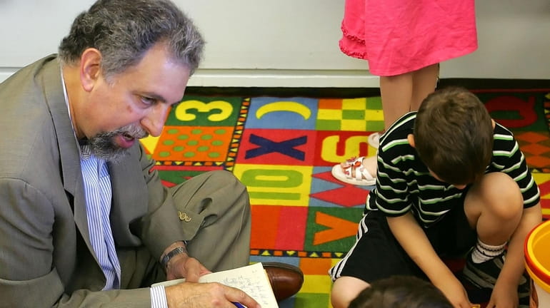 Alan Finder interviews children at a school in Ardsley, N.Y.,...