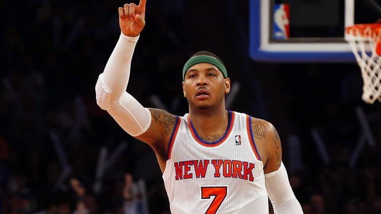 Carmelo Anthony of the Knicks celebrates after assisting on a...
