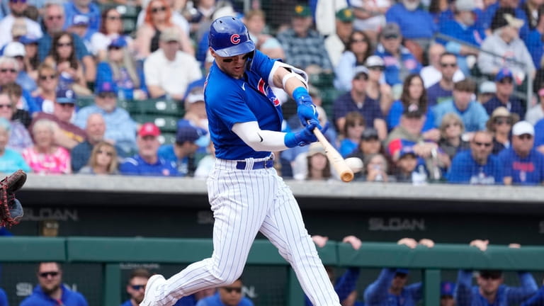 Chicago Cubs' Nico Hoerner connects for a single against the...