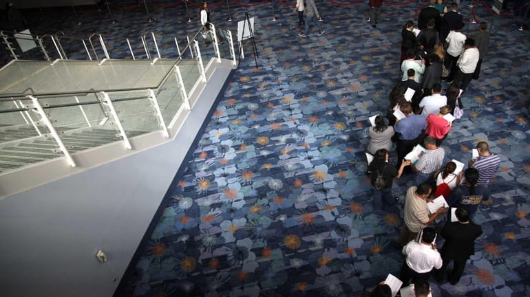 Job seekers wait in line at a career fair expo...
