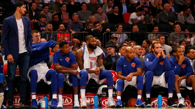 The Knicks' bench looks on during the second half of...