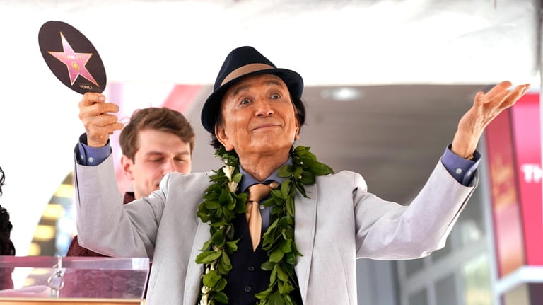 Actor James Hong gestures at a ceremony honoring him with...