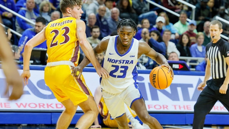 Hofstra guard Tyler Thomas (23) goes to the basket on...