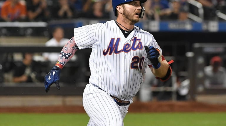 New York Mets first baseman Pete Alonso runs along the...
