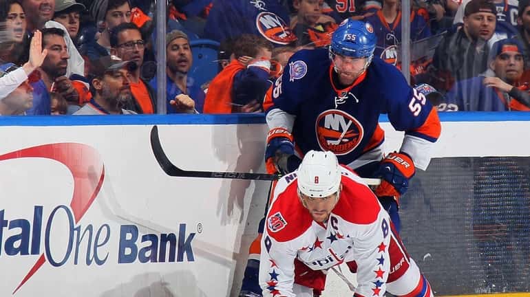 Johnny Boychuk #55 of the New York Islanders checks Alex...