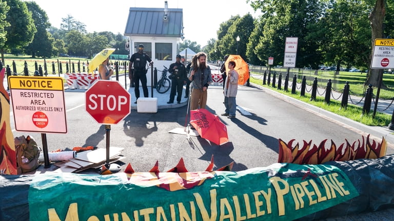 Activists with the indigenous environmental network block an entrance to...