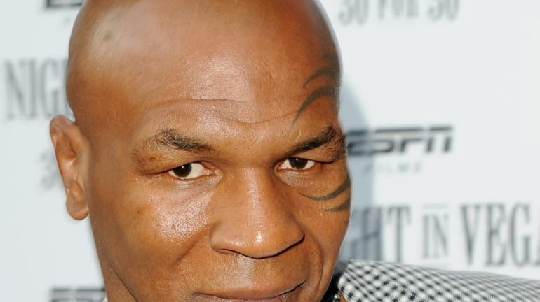 Former heavyweight boxing champion Mike Tyson and a photographer were...