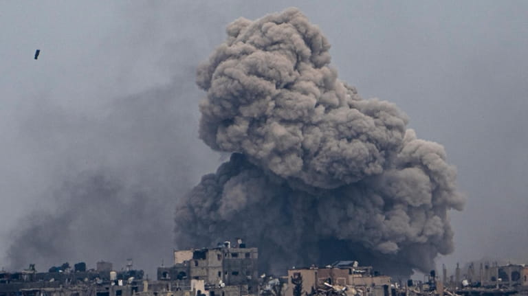 Smoke and explosions rise inside the Gaza Strip, as seen...