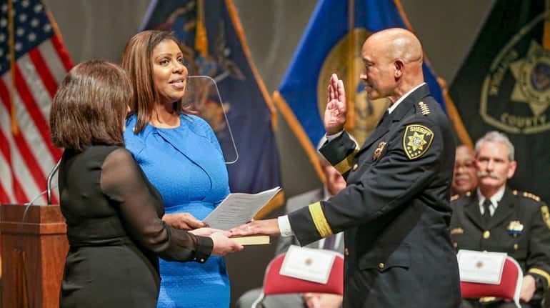 Suffolk County Sheriff Errol Toulon Jr., right, is sworn in...
