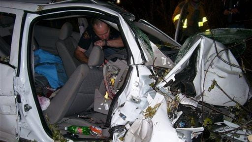 In this Oct. 24, 2006, police investigate the wreckage of...