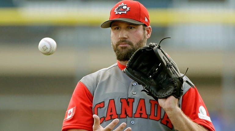 Eric Gagne, pitching for Team Canada, warms up against the...