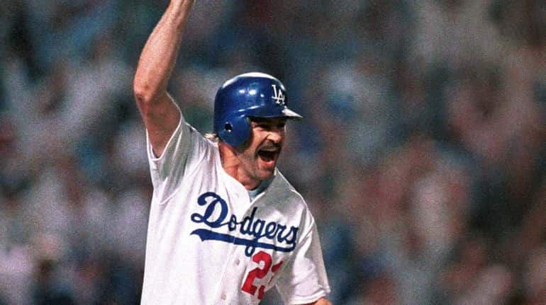 Los Angeles Dodgers' Kirk Gibson celebrates as he rounds the...