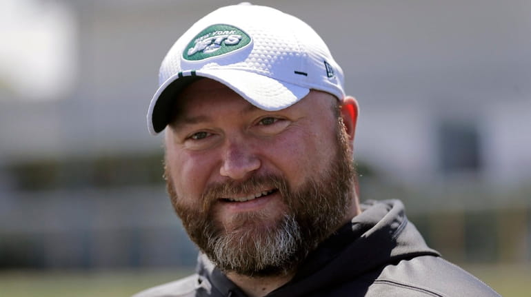 Jets general manager Joe Douglas greets reporters during a practice...