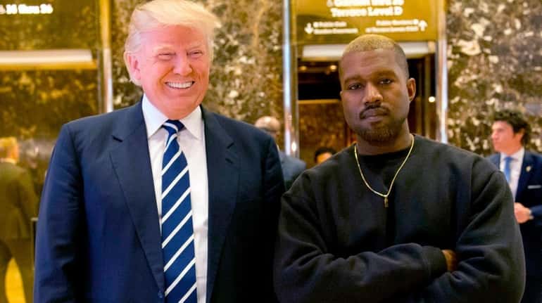 Then-President-elect Donald Trump and Kanye West in the lobby of...