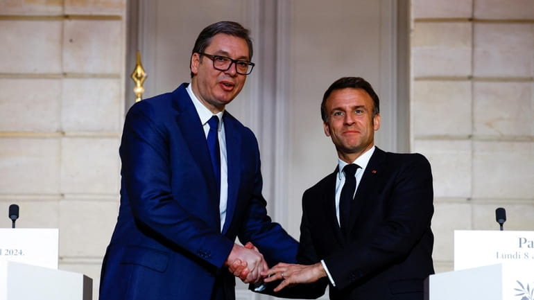 French President Emmanuel Macron, right, and Serbian President Aleksandar Vucic...