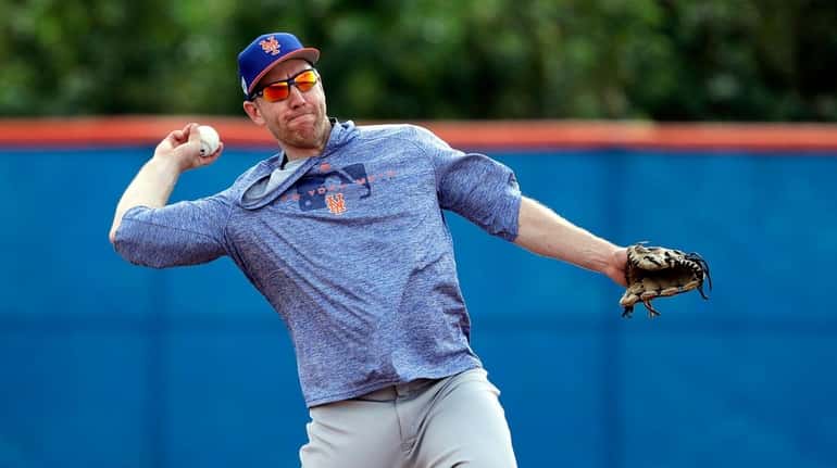 Mets infielder Todd Frazier throws to first during spring training...