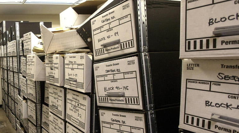 Boxes of documents are piled up June 21 in the...