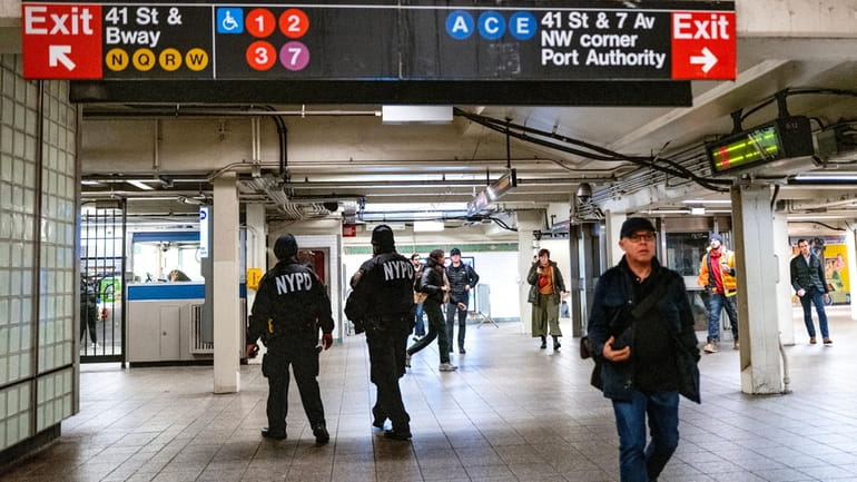 NYPD officers patrol the Times Square subway station in January. 