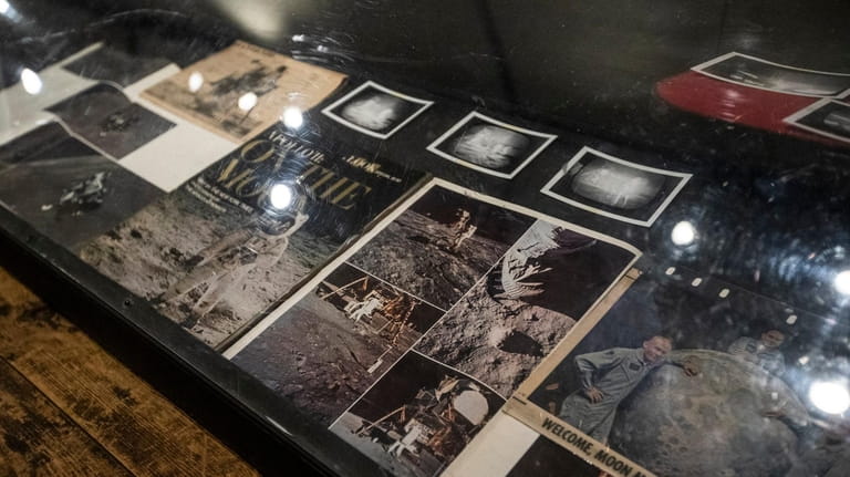 A glass case displays historical magazine clippings at Custer Institute and...