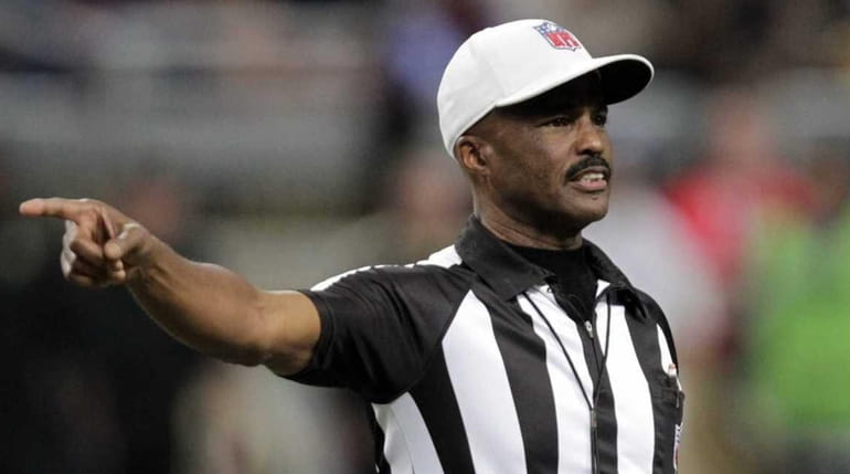 Referee Mike Carey calls a penalty during the second quarter...