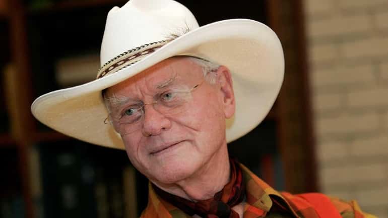 Larry Hagman listens to a reporter's question while visiting the...