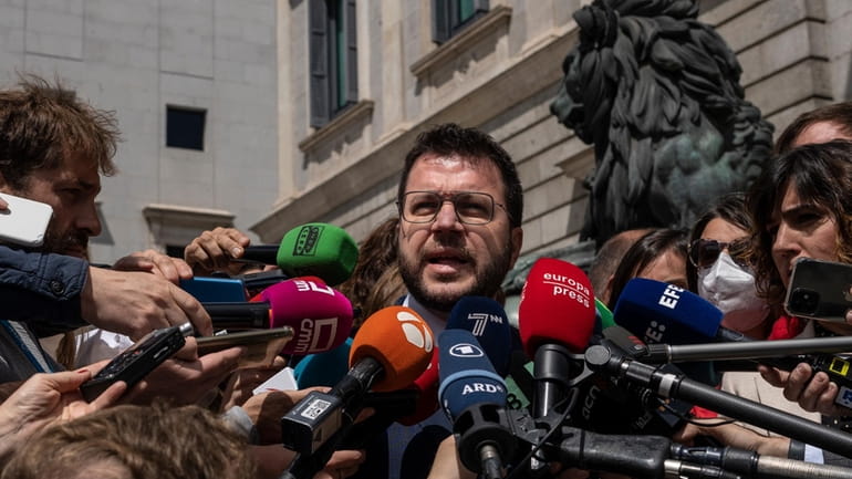Catalan President Pere Aragones addresses the media in front of...