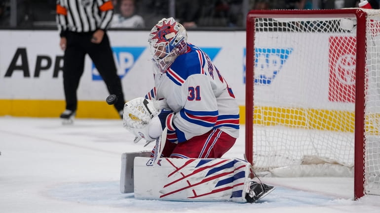Rangers goaltender Igor Shesterkin deflects a Sharks shot during the first...