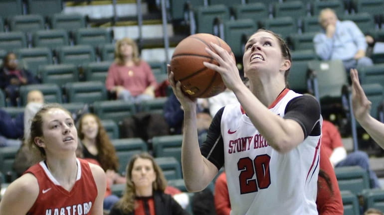 Stony Brook's Brittany Snow, center, lines up a basket while...