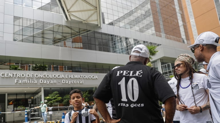 Santos soccer team supporters gather at a prayer vigil for...