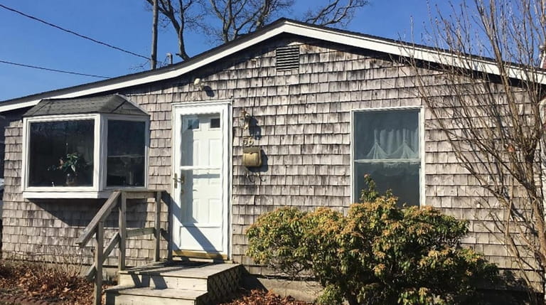 A separate cottage offers unobstructed views of Great Patchogue Lake.