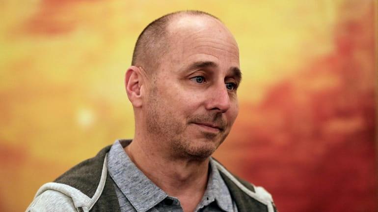 Yankees general manager Brian Cashman speaks to reporters during the...