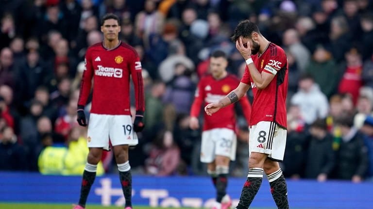 Manchester United players react after losing the English Premier League...