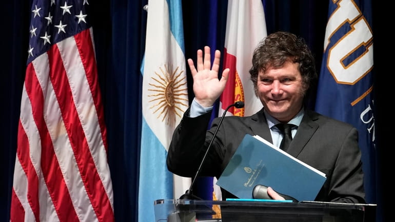 Argentine President Javier Milei waves after speaking to students at...