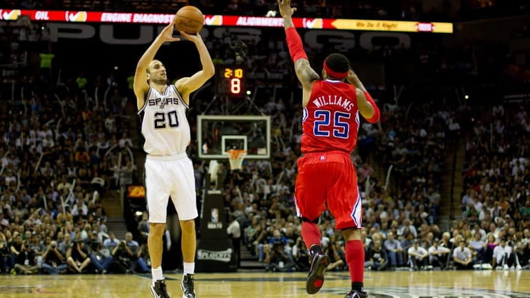 Manu Ginobili #20 of the San Antonio Spurs shoots over...